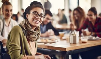 young black woman in wheelchair having lunch with friends